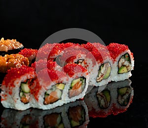 Japanese Sushi isolated on black background. Reflection in a mirror surface. Close up. Studio photo