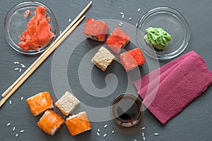 Japanese sushi made of rice and sea bass, shrimp and smoked eel with caviar of flying fish with Philadelphia cheese, chopsticks on