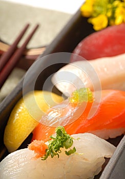 Japanese sushi nigiri with lemon and chop sticks photo