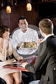 Japanese sushi restaurant, chef serving customers