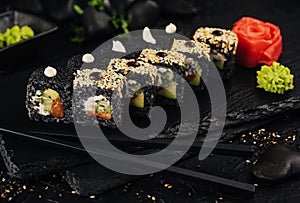 Japanese sushi rolls with black rice and caviar