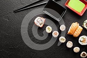 Japanese sushi rolls on black table