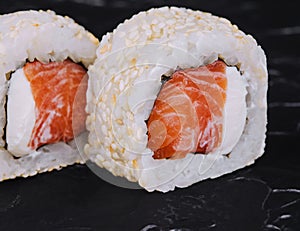 Japanese sushi rolls with salmon in rice and sesame