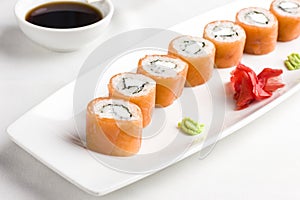 Japanese sushi rolls with salmon, serving with soy sauce, wasabi