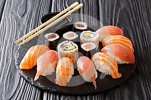 Japanese sushi on a rustic dark background. Sushi rolls, nigiri, maki, soy sauce. Sushi set on a table. Asian food. Horizontal