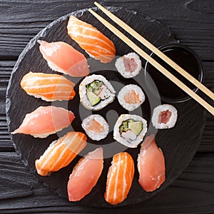 Japanese sushi on a rustic dark background. Sushi rolls, nigiri, maki, soy sauce. Sushi set on a table. Asian food. top view from