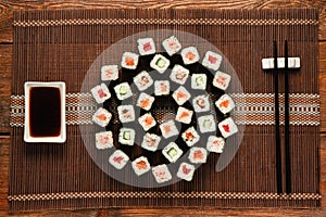 Japanese sushi set served on straw mat, flat lay