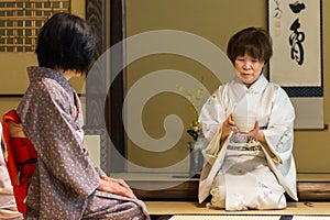 Japanese tea ceremony masters during ceremonial preparation and presentation of powdered green tea matcha