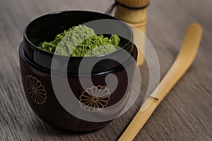 Japanese tea ceremony setting on wooden bench.