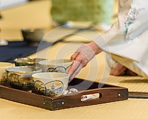 Japanese tea master serving Japanese powdered green tea matcha