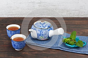Japanese teapot with cups and mint
