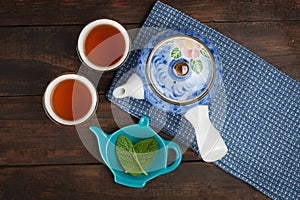Japanese teapot with two cups and mint
