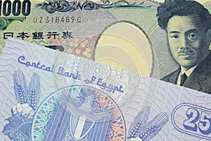 A Japanese thousand yen note paired with a blue twenty five piastre bank note from Egypt.