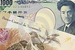 A Japanese thousand yen note paired with a colorful one hundred Bolivar bank note from Venezeula.