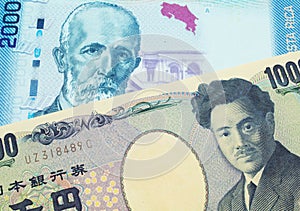 A Japanese thousand yen note paired with a colorful two thousand colones bank note from Costa Rica.