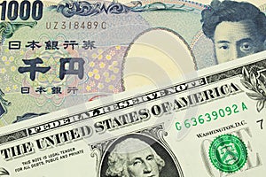 A Japanese thousand yen note paired with a green one dollar bill from the United States.