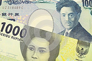 A Japanese thousand yen note paired with a green one thousand bank note from Indonesia.