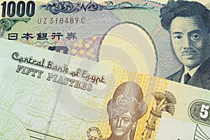 A Japanese thousand yen note paired with a green and yellow fifty piastre note from Egypt.