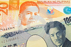 A Japanese thousand yen note paired with a orange and white twenty piso note from the Phillipines.