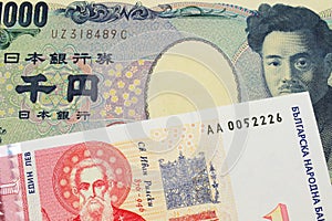 A Japanese thousand yen note paired with a red and white one lev bank note from Bulgaria.