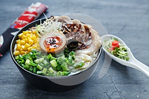 Japanese tonkotsu ramen, pork bone broth noodles with chashu, egg, corn and scallions
