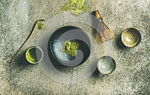 Japanese tools for brewing matcha green tea, grey concrete background