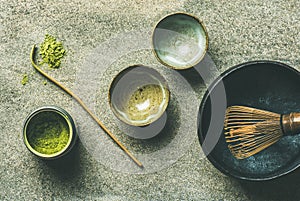 Japanese tools for brewing matcha tea, grey background, top view