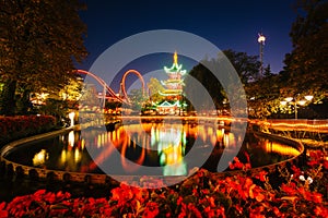 The Japanese Tower and rides at night, reflecting in a lake at T