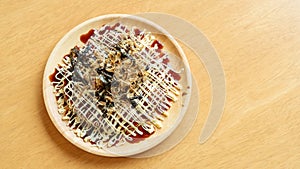 Japanese traditional pancakes (Okonomiyaki) on a wooden table