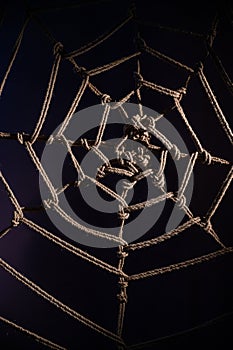 Japanese traditional technique of knitting shibari ropes in the form of a spider web. No people. Part of the bedroom