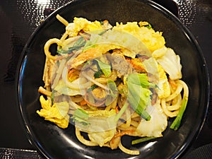 Japanese udon stir fried with chicken and tempura