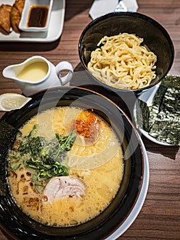Japanese white broth ramen served with extra noodle and seaweed. Top view