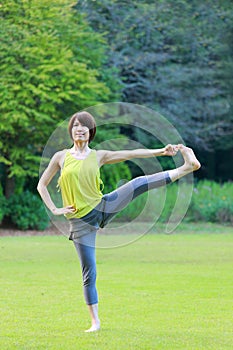 Japanese Woman Doing YOGA Extended Hand-To-Big-Toe Pose