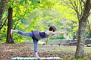 Japanese Woman Doing YOGA warrior III pose