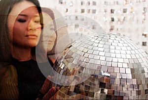 Japanese woman holds glitterball