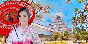 Japanese woman in Kimono dress at Aizuwakamatsu Castle and cherry blossom in Fukushima, Japan