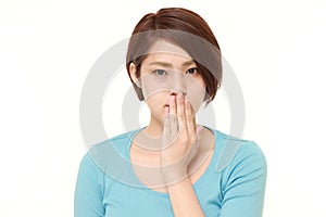 Japanese woman making the speak no evil gesture