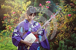 Japanese woman playing traditional shamisen