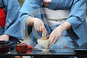 Japanese woman preparing green tea ceremony