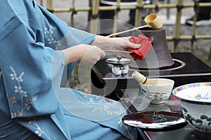 Japanese woman preparing green tea ceremony