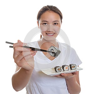 Japanese woman tasting fresh sushi rolls