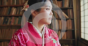 Japanese woman, thinking and traditional clothes in library for mindfulness and vision in religion education. Young