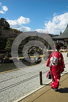 A Japanese woman in traditional dress at a temple in Kyoto
