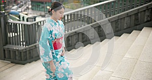 Japanese woman, traditional and walking on stairs in city, travel and wellness on steps for peace attitude outdoor