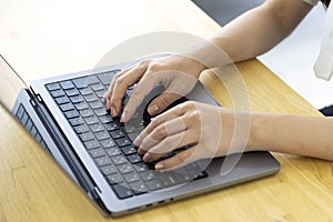 A Japanese woman typing laptop by remote work in the office faceless composition