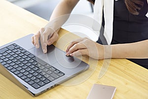 A Japanese woman typing laptop by remote work in the office faceless composition