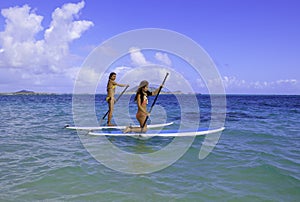 Japanese women on paddleboards