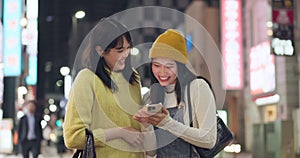 Japanese women, phone and city for night travel with social media, happy news or information. People or friends talk and