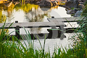 Japanese wooden bridge over pond