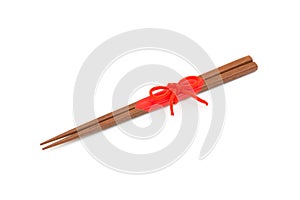 Japanese wooden chopsticks wrapped in red paper and red rope on